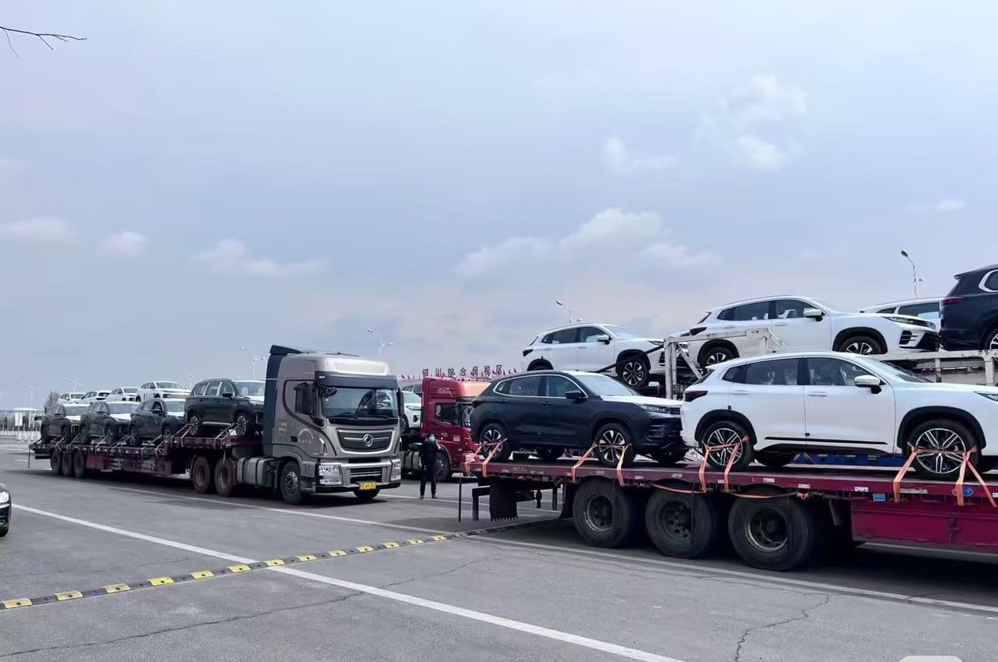 Car carrier trucks loaded with new vehicles on the way to port