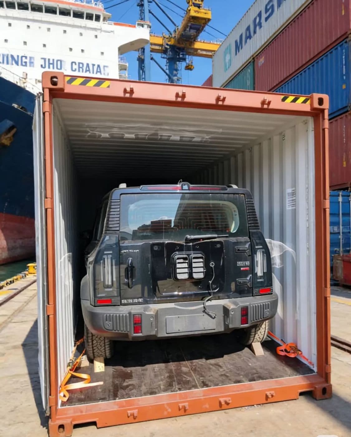 SUV strapped inside a shipping container ready for sealing